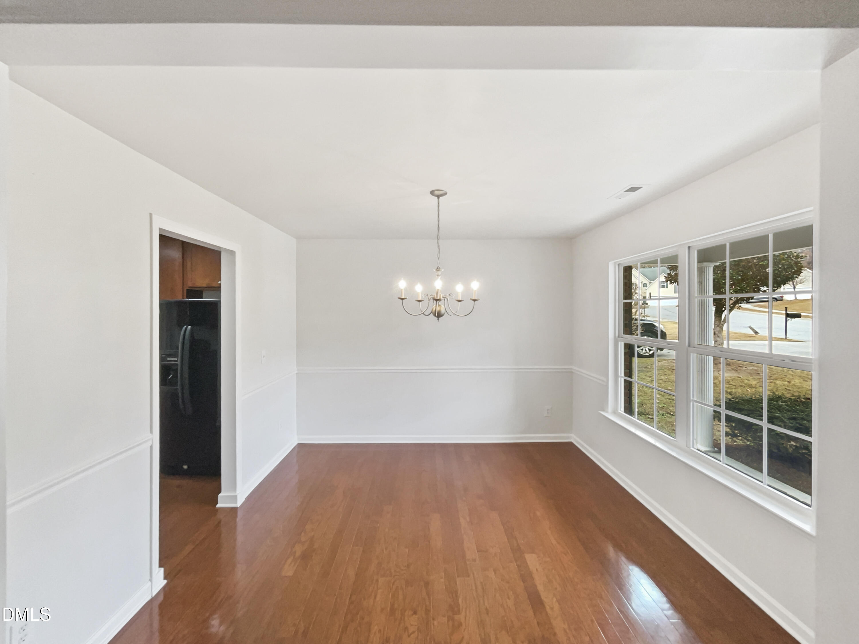 5512 Quitman Trail Raleigh, NC 27610 - Photo 10 of 18 a view of a room with wooden floor and large windows