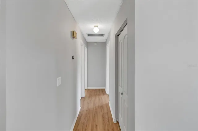a view of a hallway with wooden floor