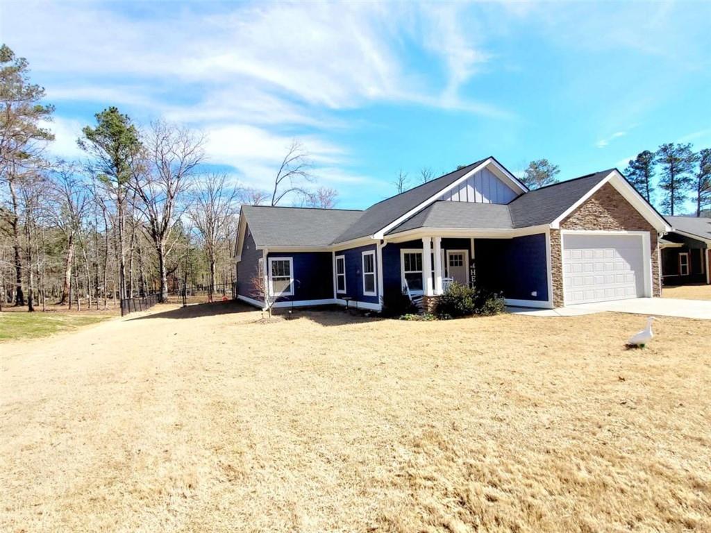 12 Southwest Gowen Drive Southwest Rome, GA 30165 - Photo 1 of 1 a front view of a house with a yard covered in snow