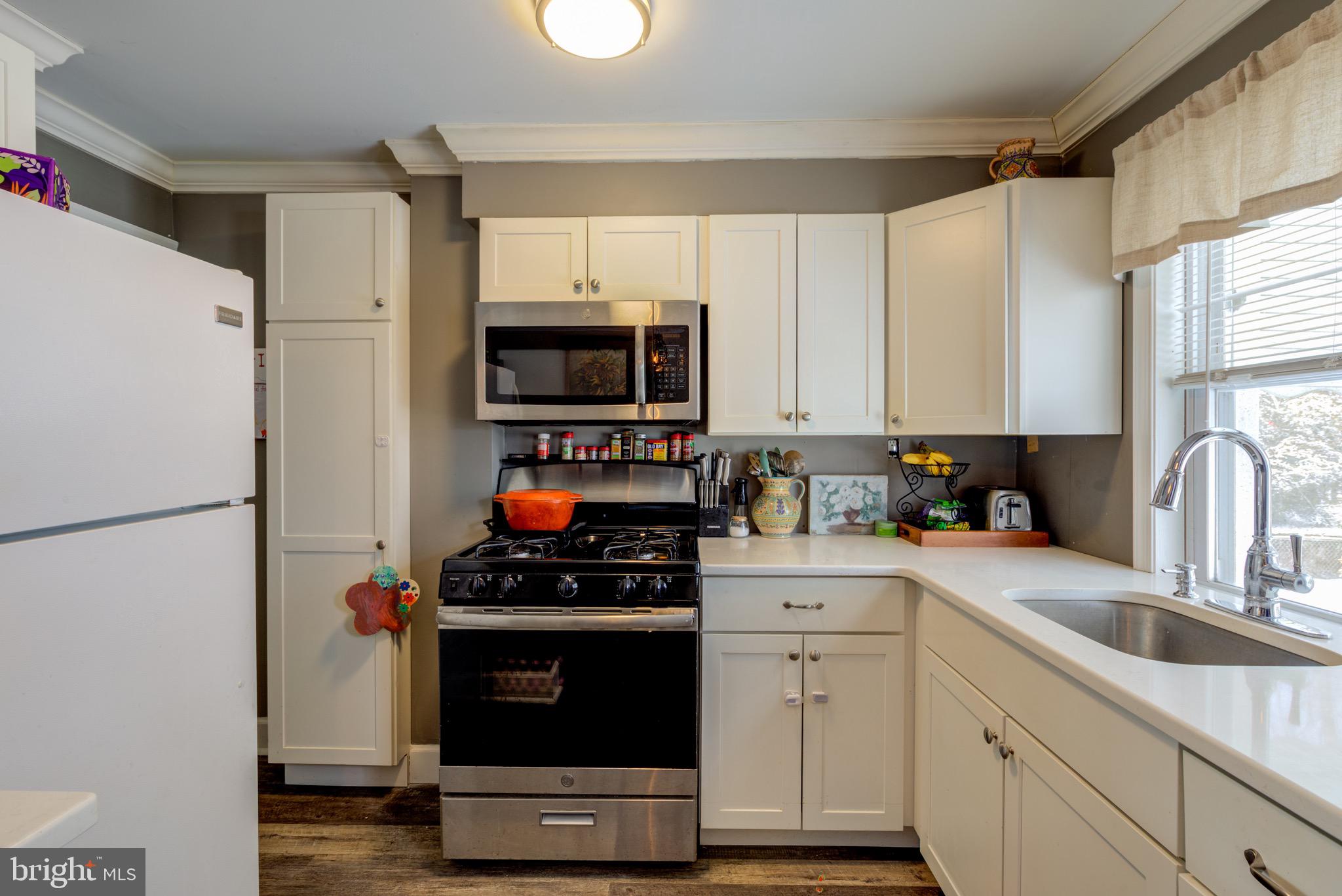 203 Overlook Road Philadelphia, PA 19128 - Photo 11 of 32 a kitchen with appliances a refrigerator and a sink