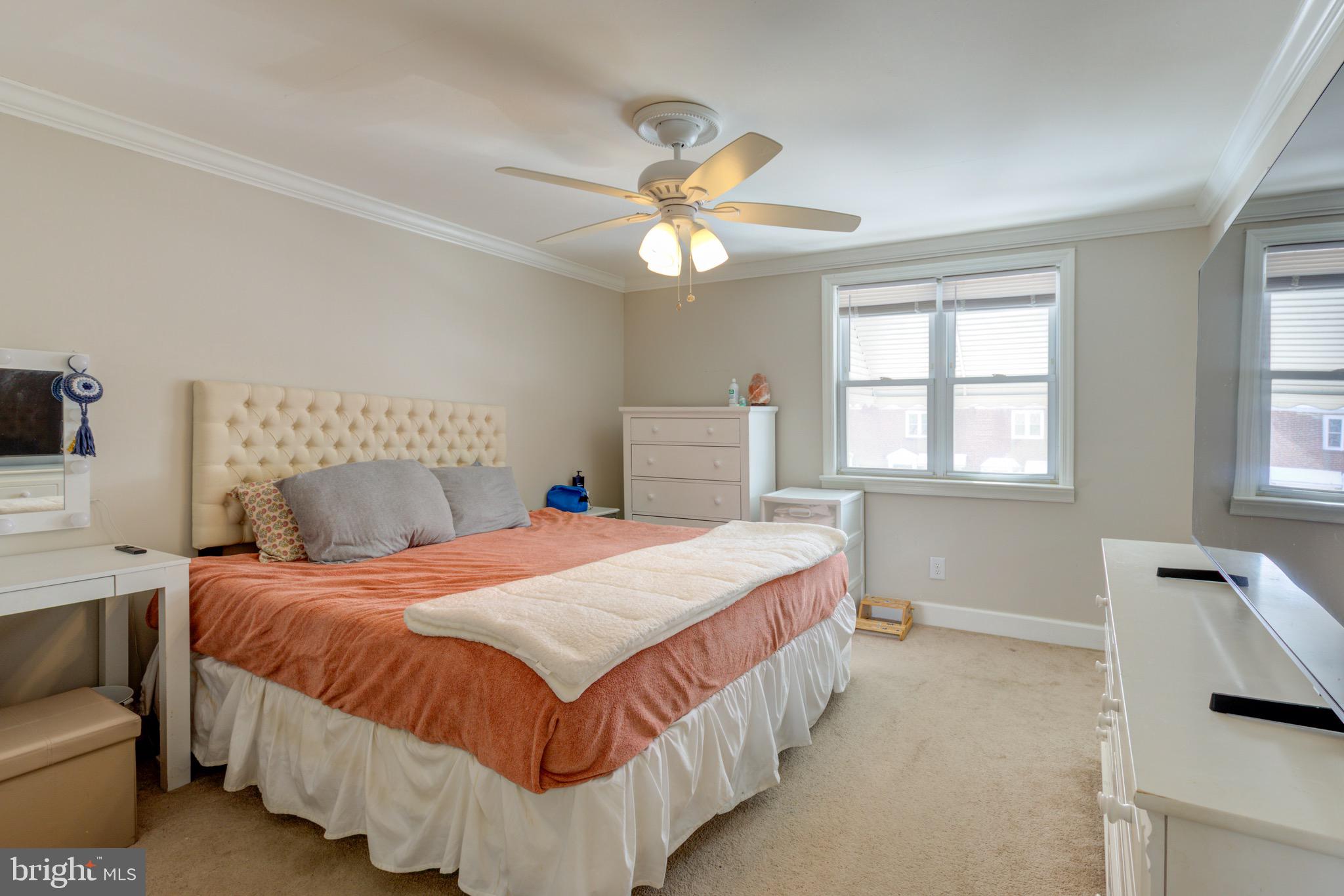 203 Overlook Road Philadelphia, PA 19128 - Photo 14 of 32 a bedroom with a bed and a chandelier