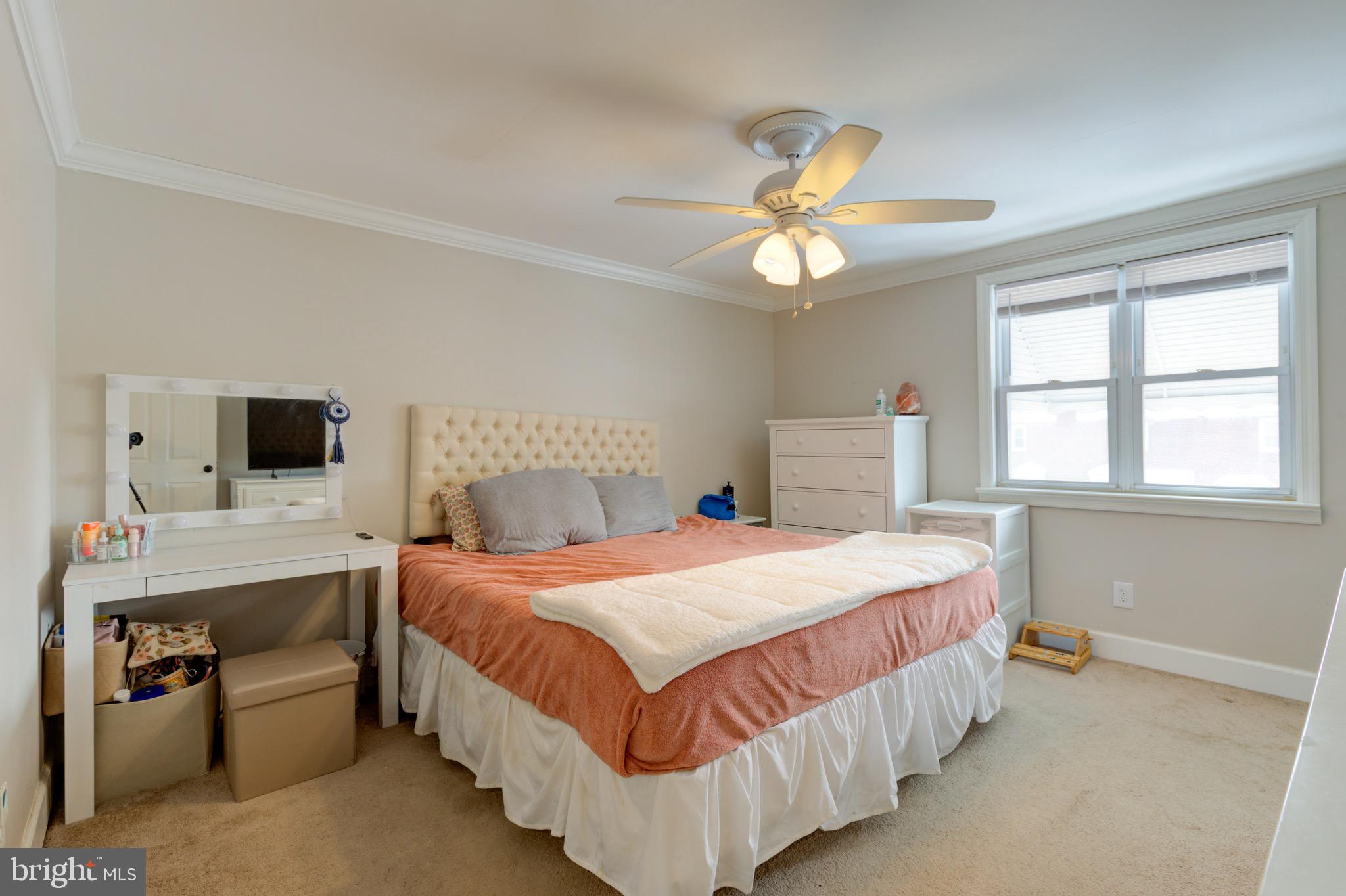 203 Overlook Road Philadelphia, PA 19128 - Photo 15 of 32 a bedroom with a bed and a chandelier