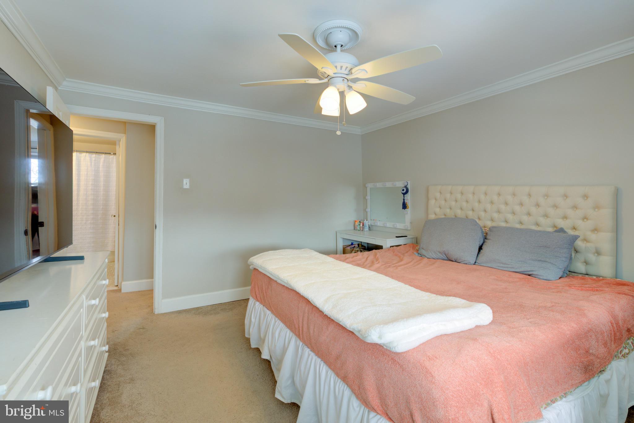 203 Overlook Road Philadelphia, PA 19128 - Photo 17 of 32 a bedroom with a bed and a chandelier