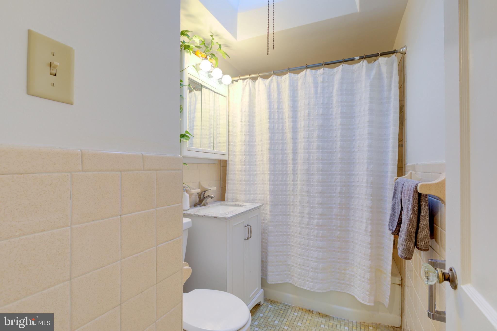 203 Overlook Road Philadelphia, PA 19128 - Photo 18 of 32 a bathroom with a sink a toilet and shower curtain