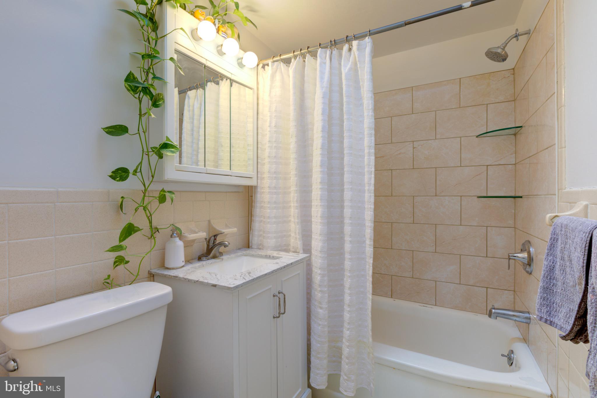 203 Overlook Road Philadelphia, PA 19128 - Photo 19 of 32 a bathroom with a granite countertop sink a toilet and shower