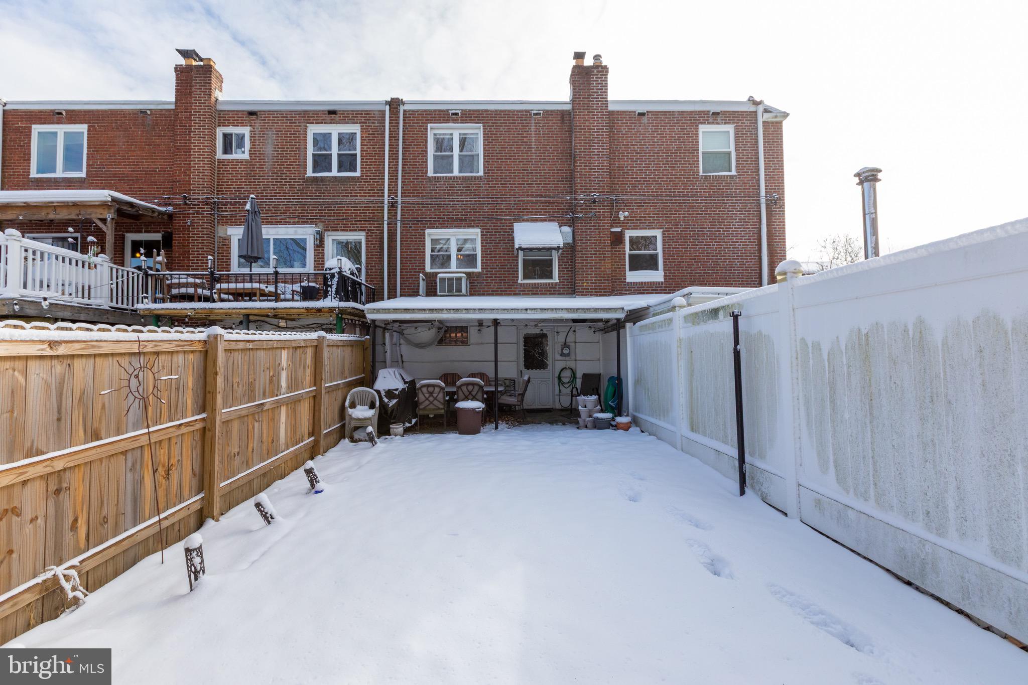 203 Overlook Road Philadelphia, PA 19128 - Photo 31 of 32 a view of a house with a barbeque and wooden fence
