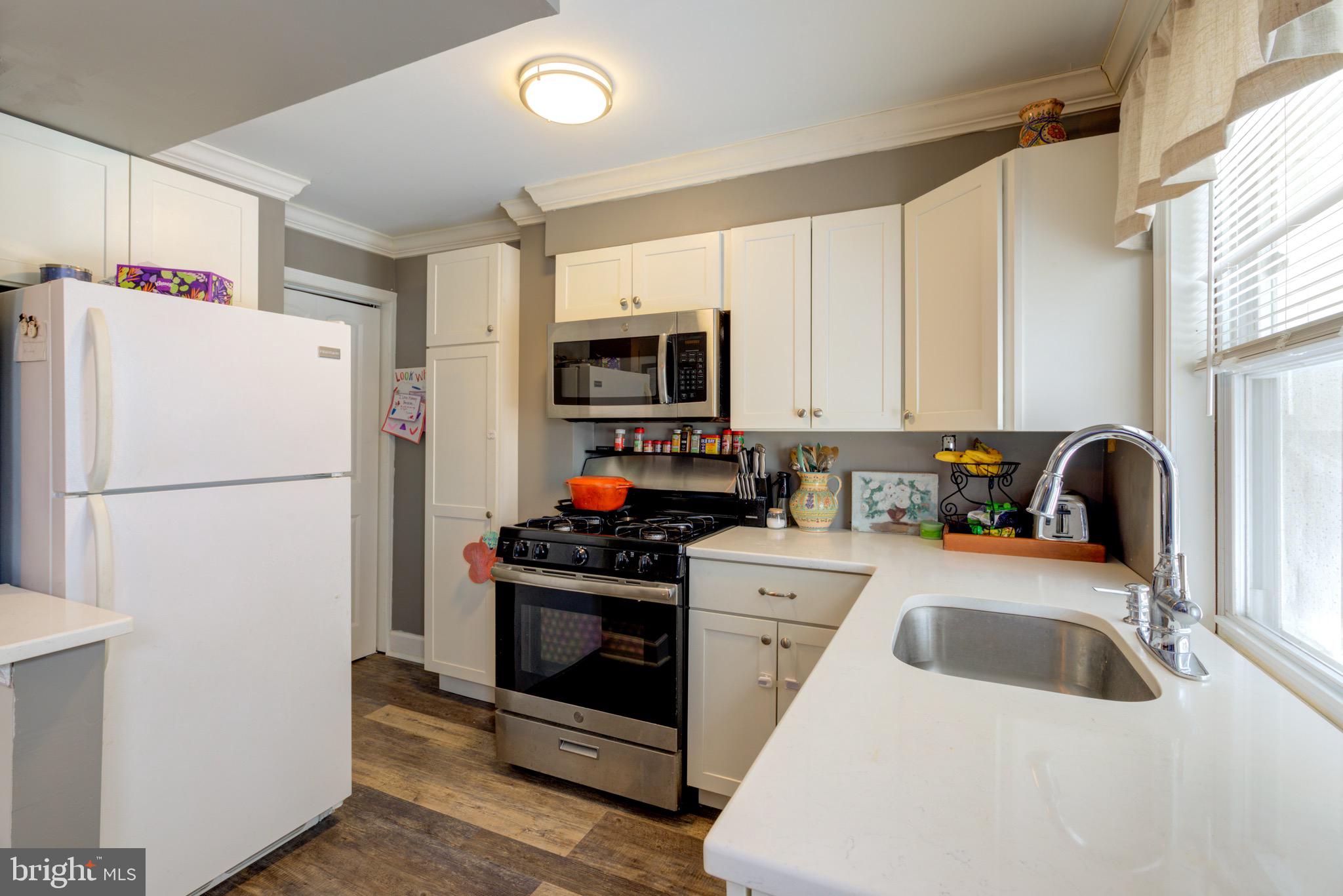 203 Overlook Road Philadelphia, PA 19128 - Photo 10 of 32 a kitchen with a sink a refrigerator and a stove top oven