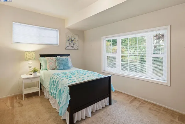 a bedroom with a bed and window