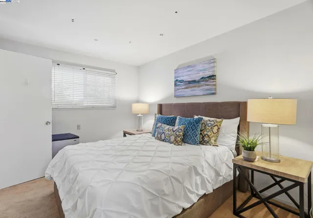 a bedroom with a bed and a lamp