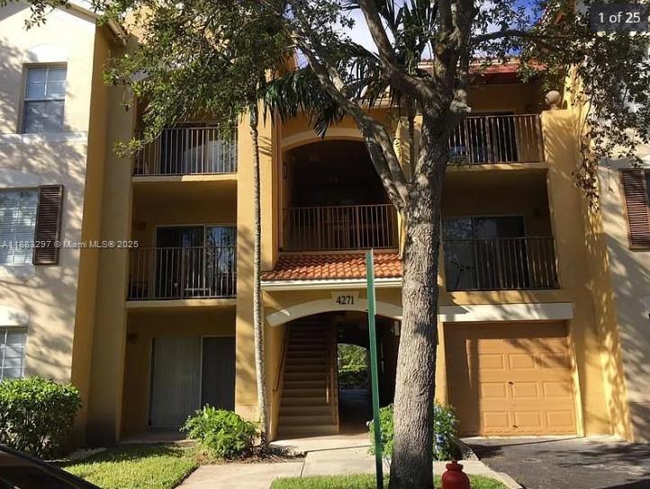 4271 San Marino Boulevard, Unit 206 West Palm Beach, FL 33409 - Photo 1 of 9 a front view of a house with a tree