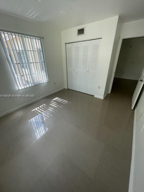 4271 San Marino Boulevard, Unit 206 West Palm Beach, FL 33409 - Photo 7 of 9 a view of an empty room with windows