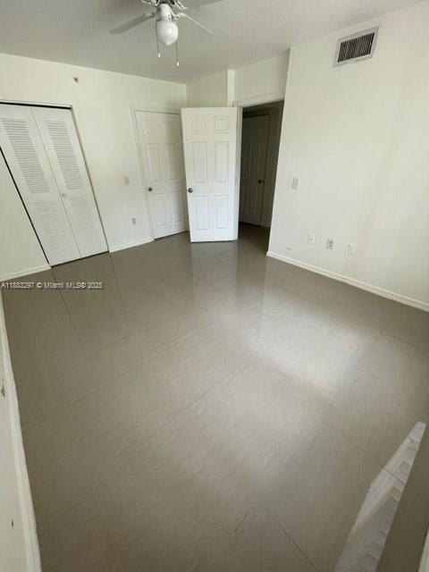 4271 San Marino Boulevard, Unit 206 West Palm Beach, FL 33409 - Photo 8 of 9 an empty room with a ceiling fan