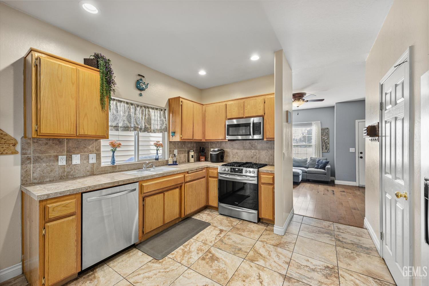 Undisclosed Address Bakersfield, CA 93301 - Photo 22 of 30 a large kitchen with stainless steel appliances granite countertop a sink and cabinets