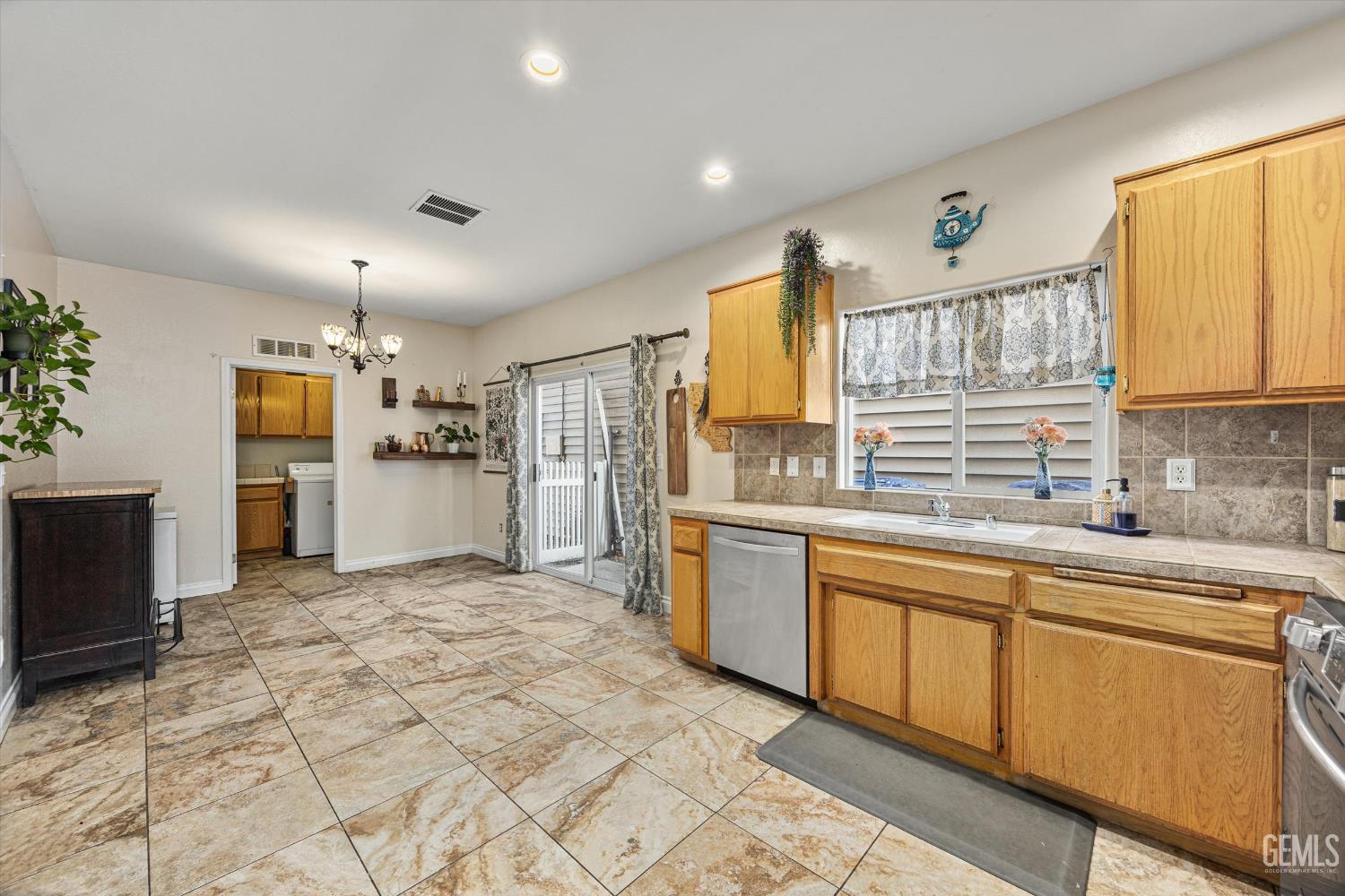 Undisclosed Address Bakersfield, CA 93301 - Photo 23 of 30 a kitchen with granite countertop a sink appliances cabinets and counter space