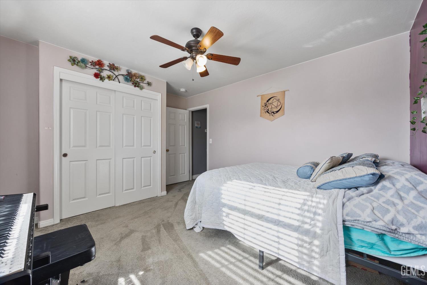 Undisclosed Address Bakersfield, CA 93301 - Photo 28 of 30 a bedroom with a bed and a chandelier
