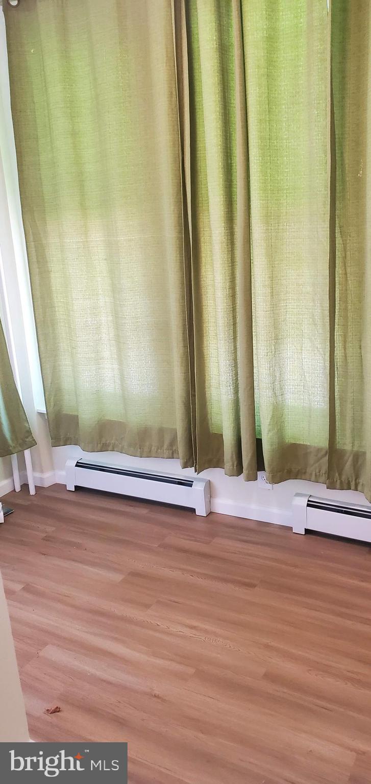 5921 Chancellor Street Philadelphia, PA 19139 - Photo 3 of 12 a view of a room with wooden floor and a window