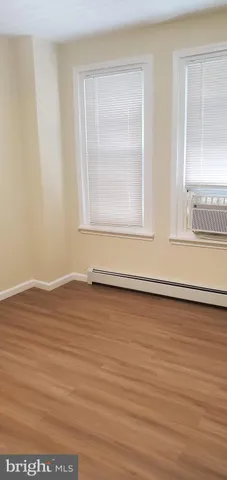 a view of a room with wooden floor and cabinet