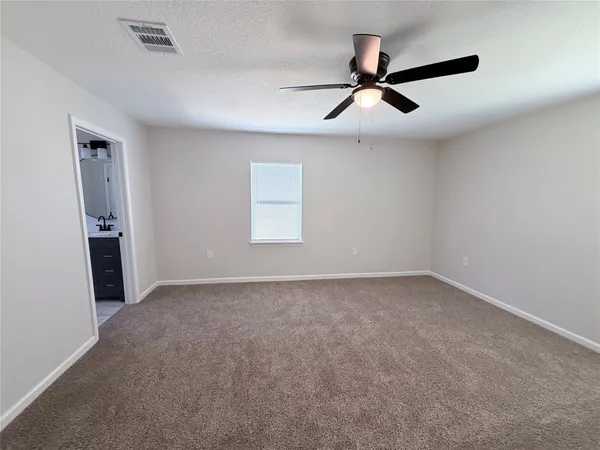 a view of a livingroom with a ceiling fan and window