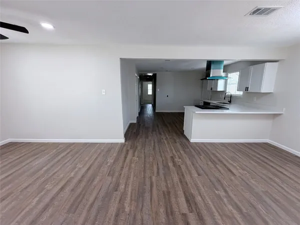 a view of kitchen with sink and wooden floor