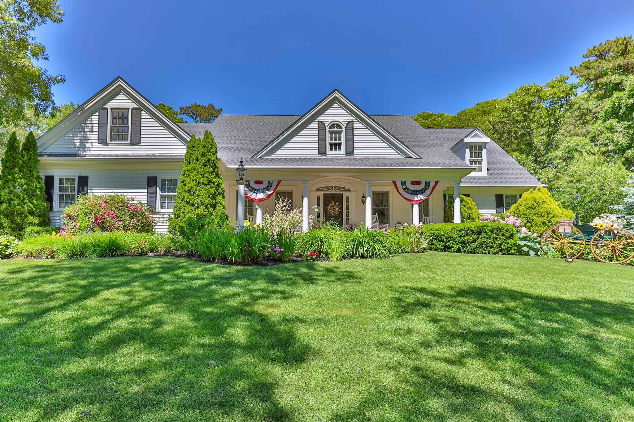 201 Forest Street Harwich, MA 02645 - Photo 3 of 59 a front view of a house with a yard