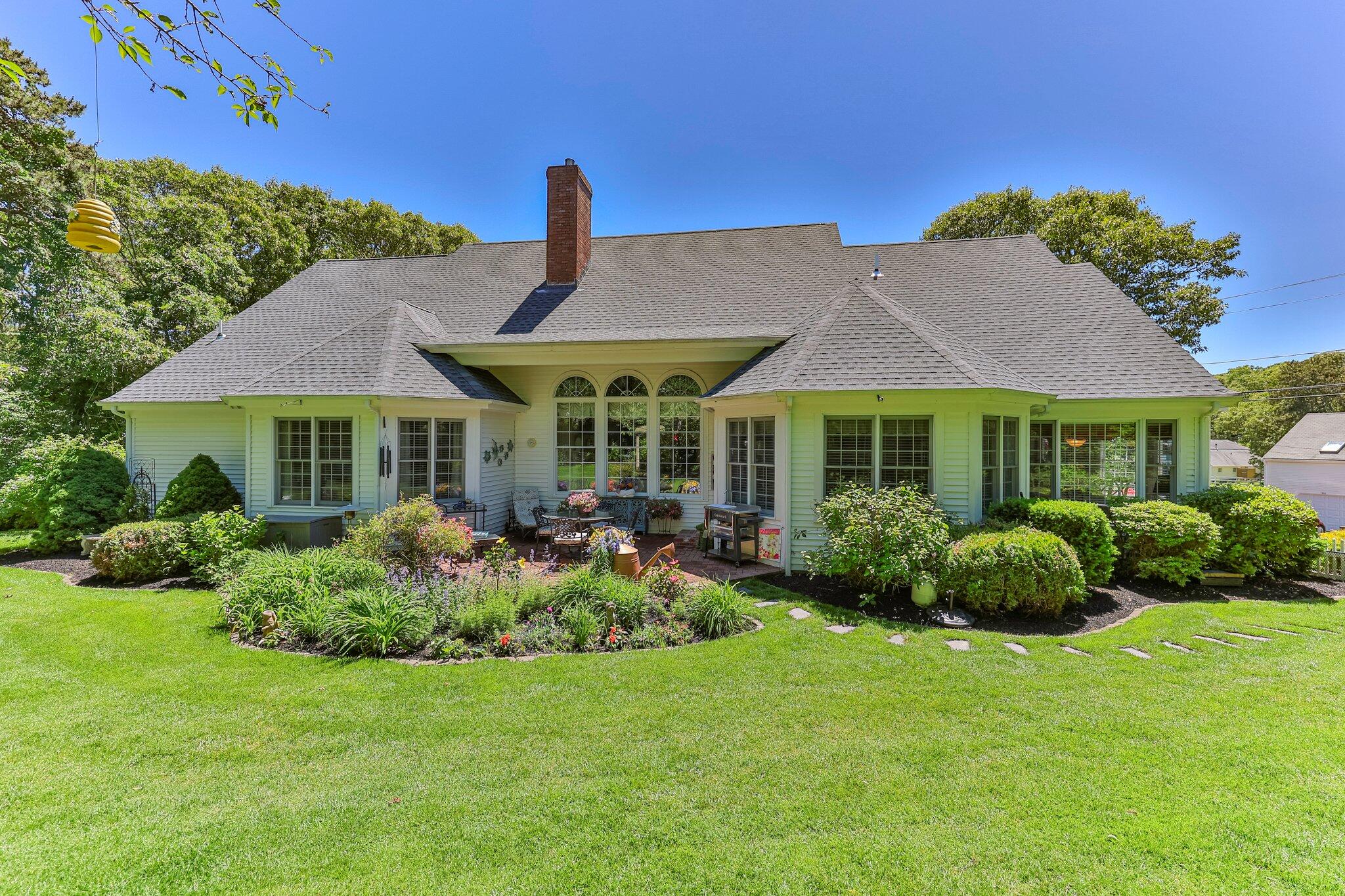 201 Forest Street Harwich, MA 02645 - Photo 49 of 59 a front view of a house with garden and porch