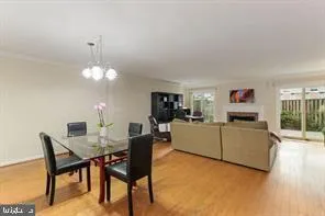 a living room with furniture a chandelier and a dining table
