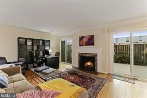 a living room with furniture a rug and a fireplace