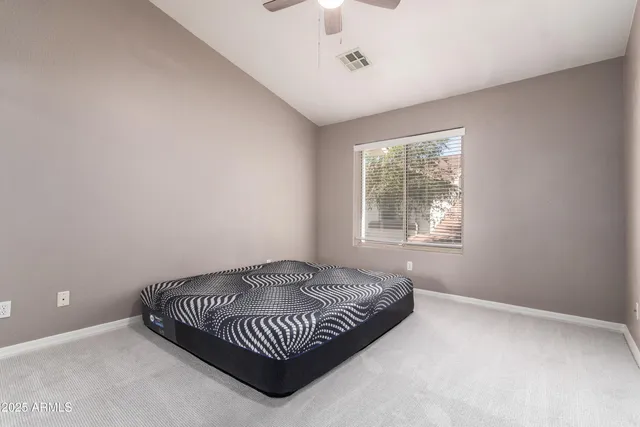 a living room with a bed and a window