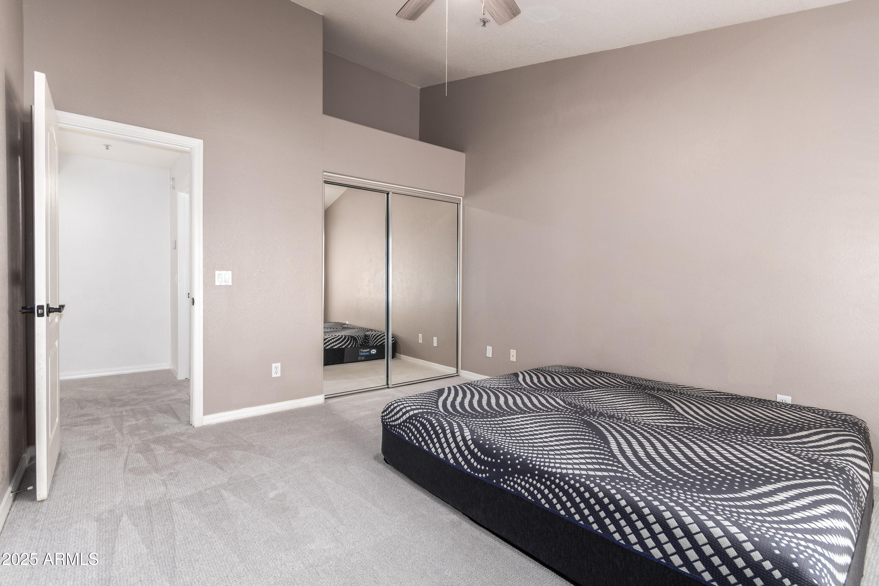 2201 North Comanche Drive, Unit 1080 Chandler, AZ 85224 - Photo 15 of 18 a bedroom with a bed and a walk in closet