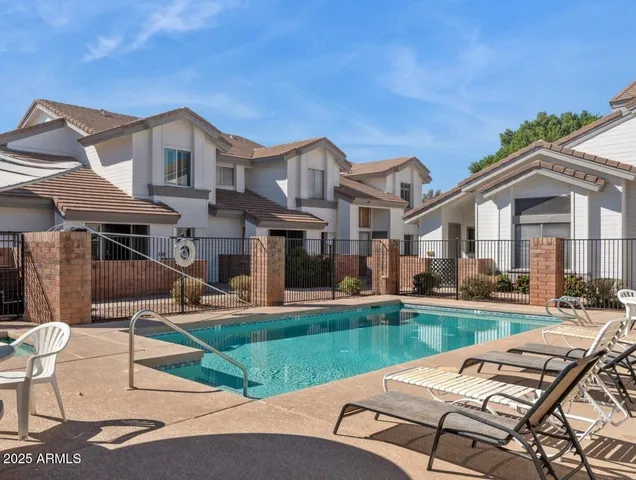 a front view of a house with swimming pool having outdoor seating