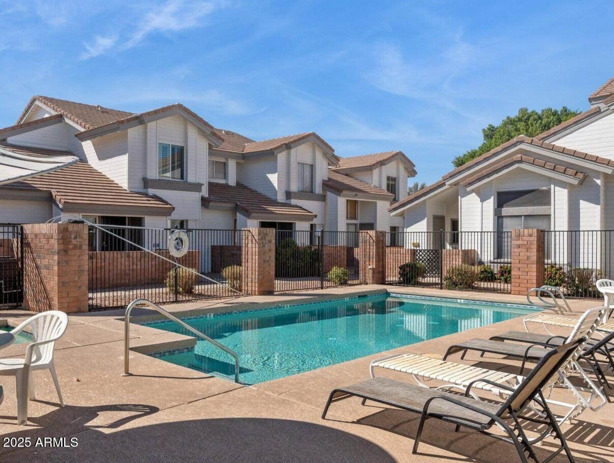 2201 North Comanche Drive, Unit 1080 Chandler, AZ 85224 - Photo 18 of 18 a front view of a house with swimming pool having outdoor seating