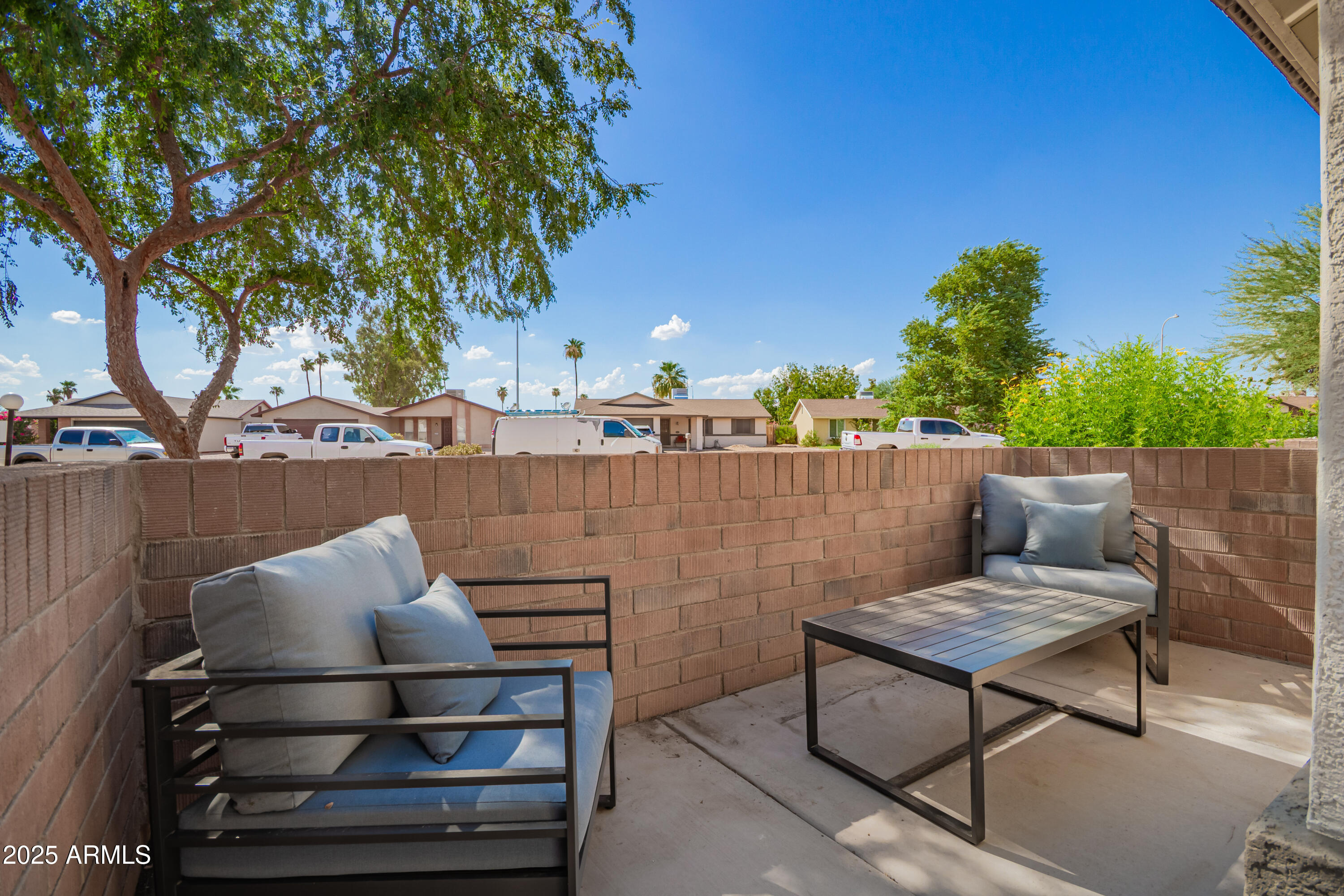 2201 North Comanche Drive, Unit 1080 Chandler, AZ 85224 - Photo 3 of 18 a backyard of a house with table and chairs