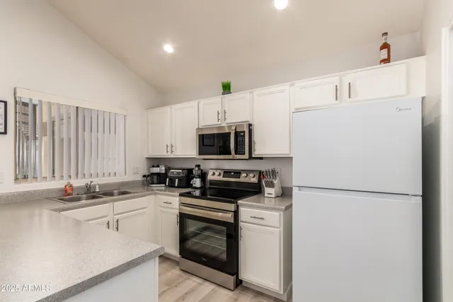 a kitchen with appliances a sink and a counter top space