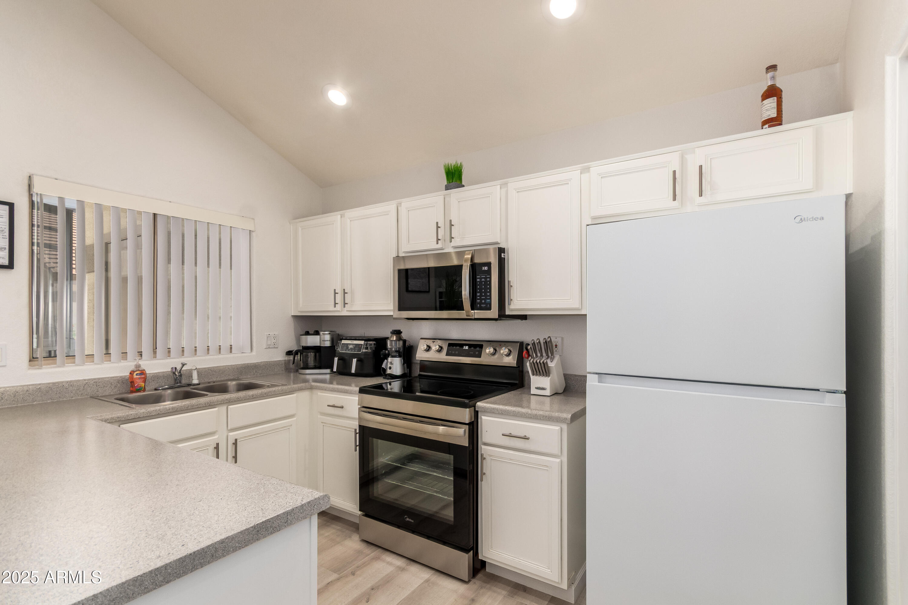 2201 North Comanche Drive, Unit 1080 Chandler, AZ 85224 - Photo 10 of 18 a kitchen with appliances a sink and a counter top space