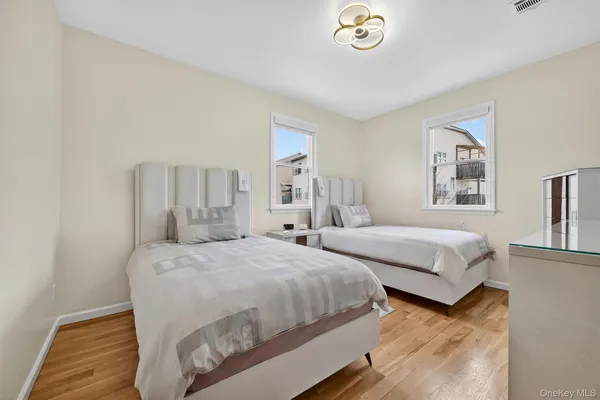 a bedroom with a large bed and a large mirror