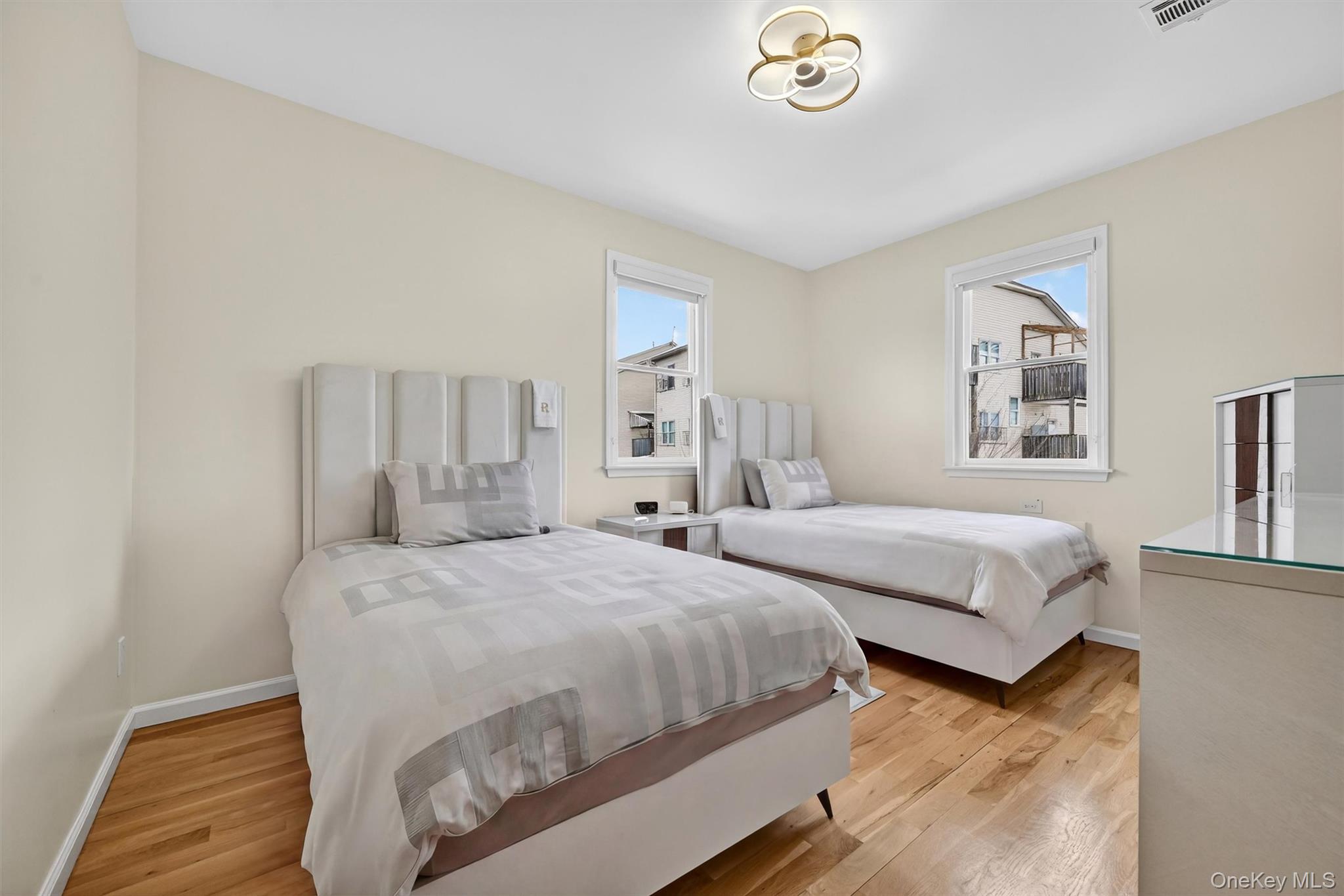 6 Garfield Road, Unit 311 Monroe, NY 10950 - Photo 13 of 32 a bedroom with two beds and a chandelier