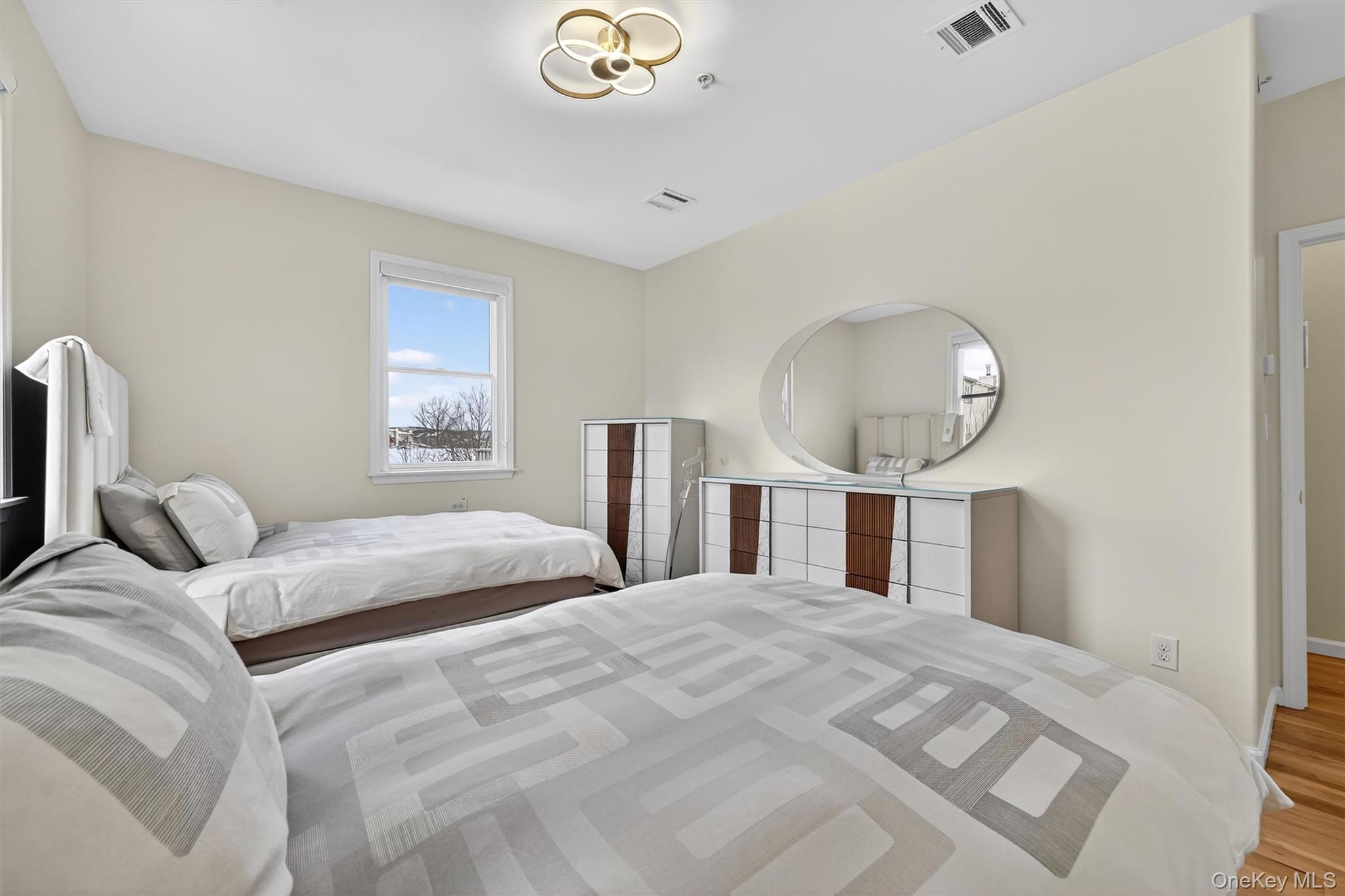 6 Garfield Road, Unit 311 Monroe, NY 10950 - Photo 14 of 32 a bedroom with a large bed and a large mirror