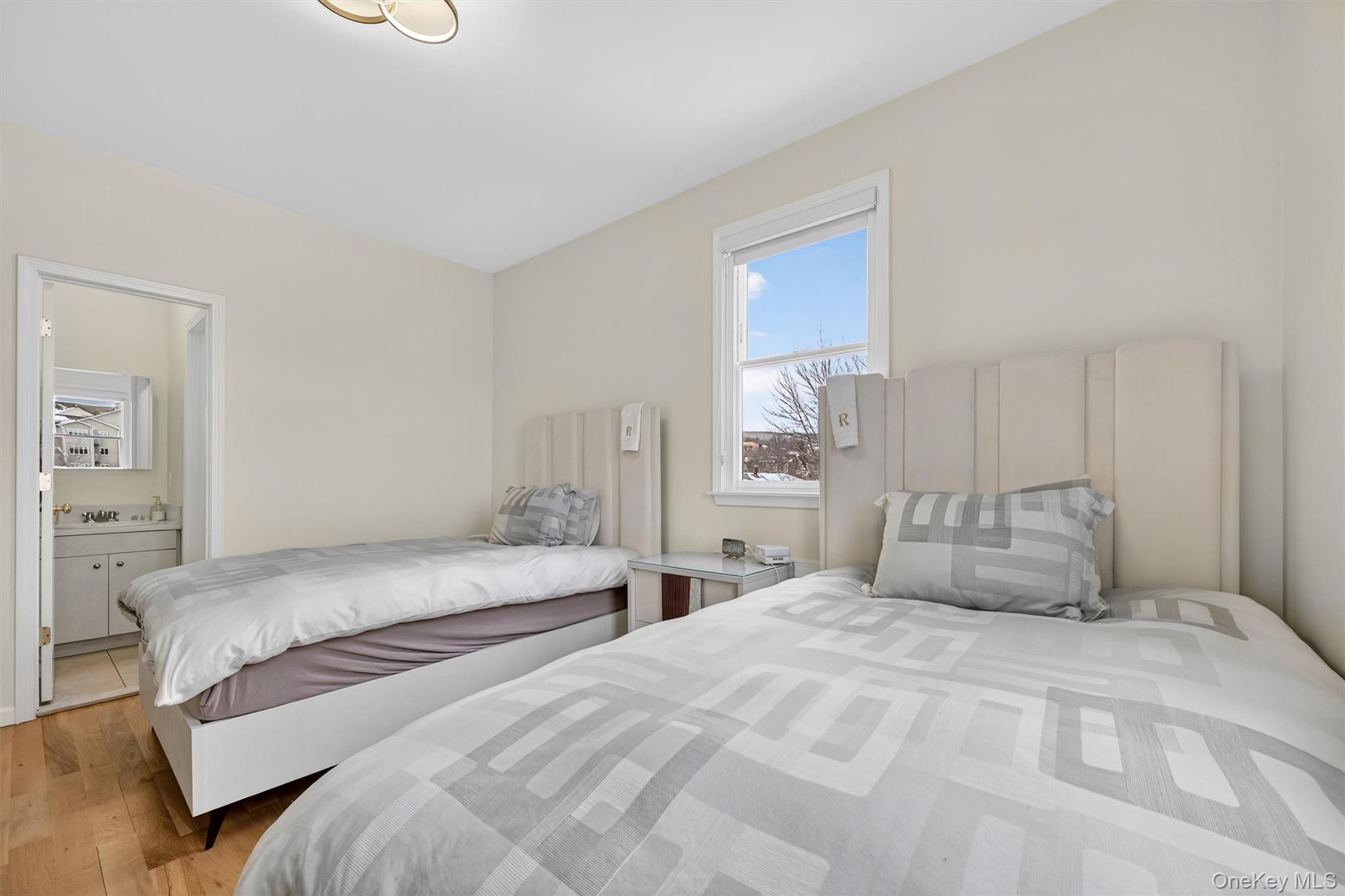 6 Garfield Road, Unit 311 Monroe, NY 10950 - Photo 15 of 32 a bedroom with two beds and a large window