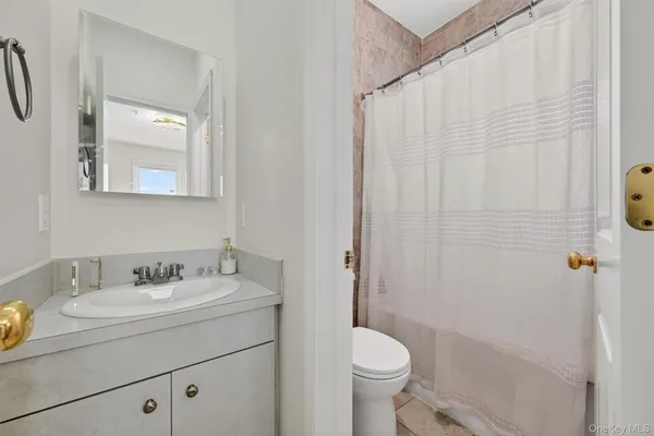 a bathroom with a toilet and bathtub