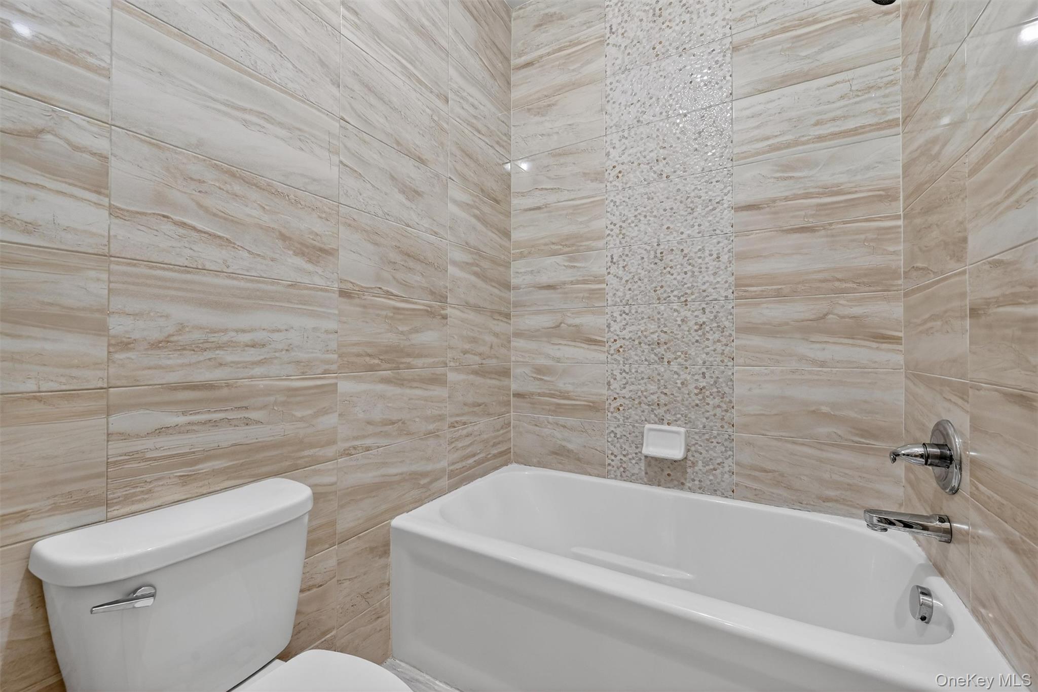 6 Garfield Road, Unit 311 Monroe, NY 10950 - Photo 18 of 32 a bathroom with a toilet and bathtub