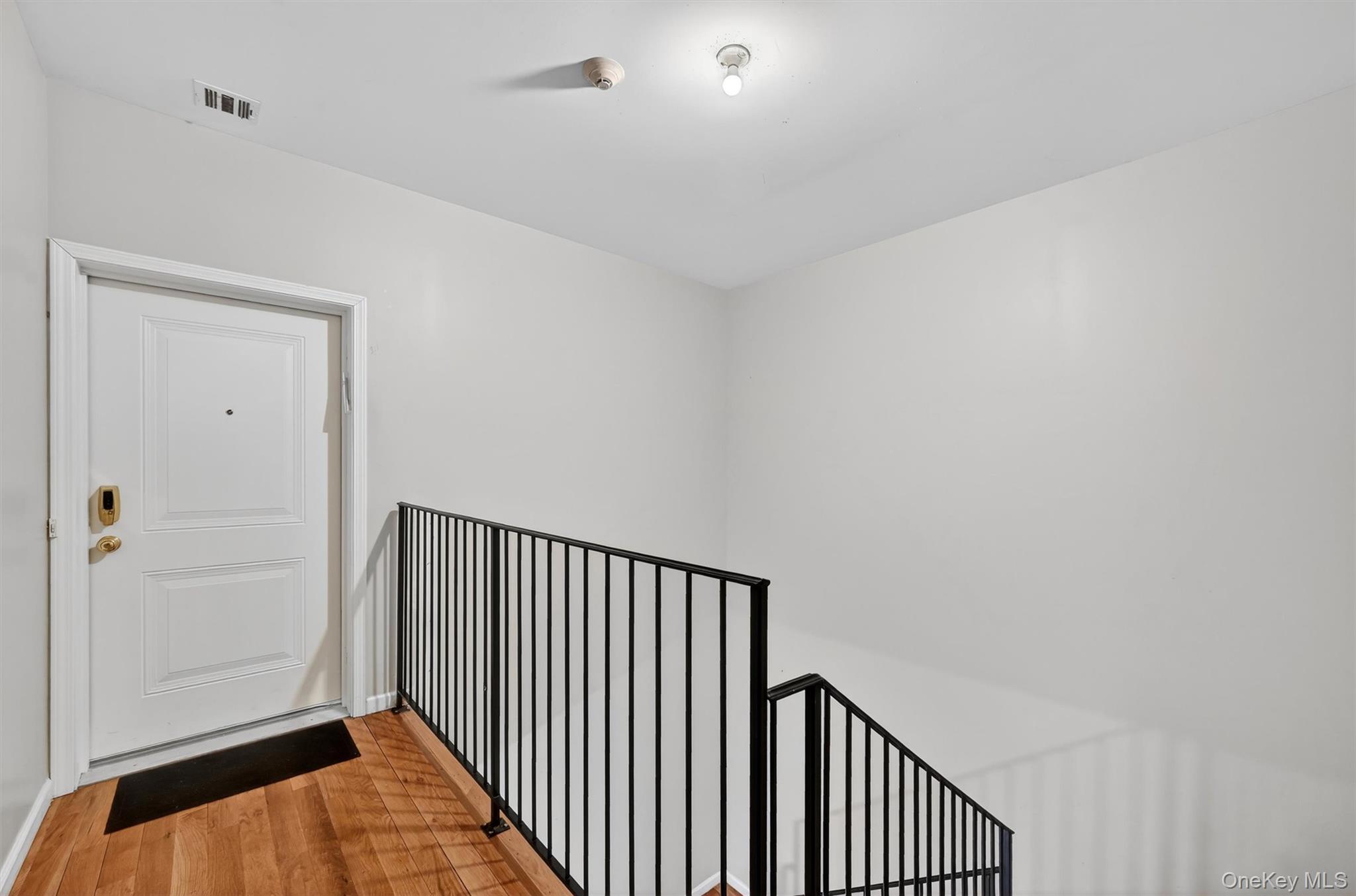 6 Garfield Road, Unit 311 Monroe, NY 10950 - Photo 23 of 32 a view of a hallway with wooden floor and a bathroom