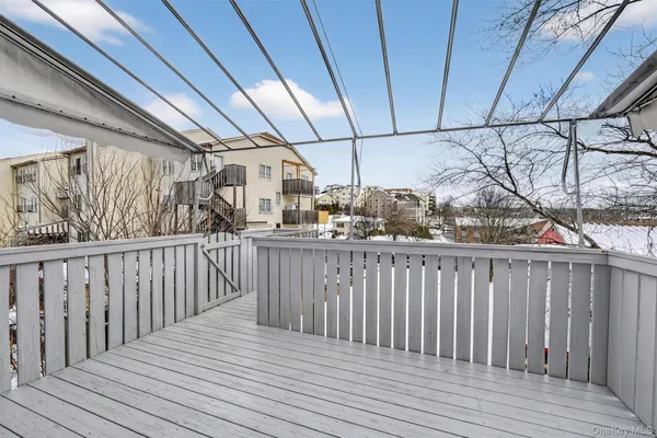 a view of a deck with wooden floor and fence with a wooden fence