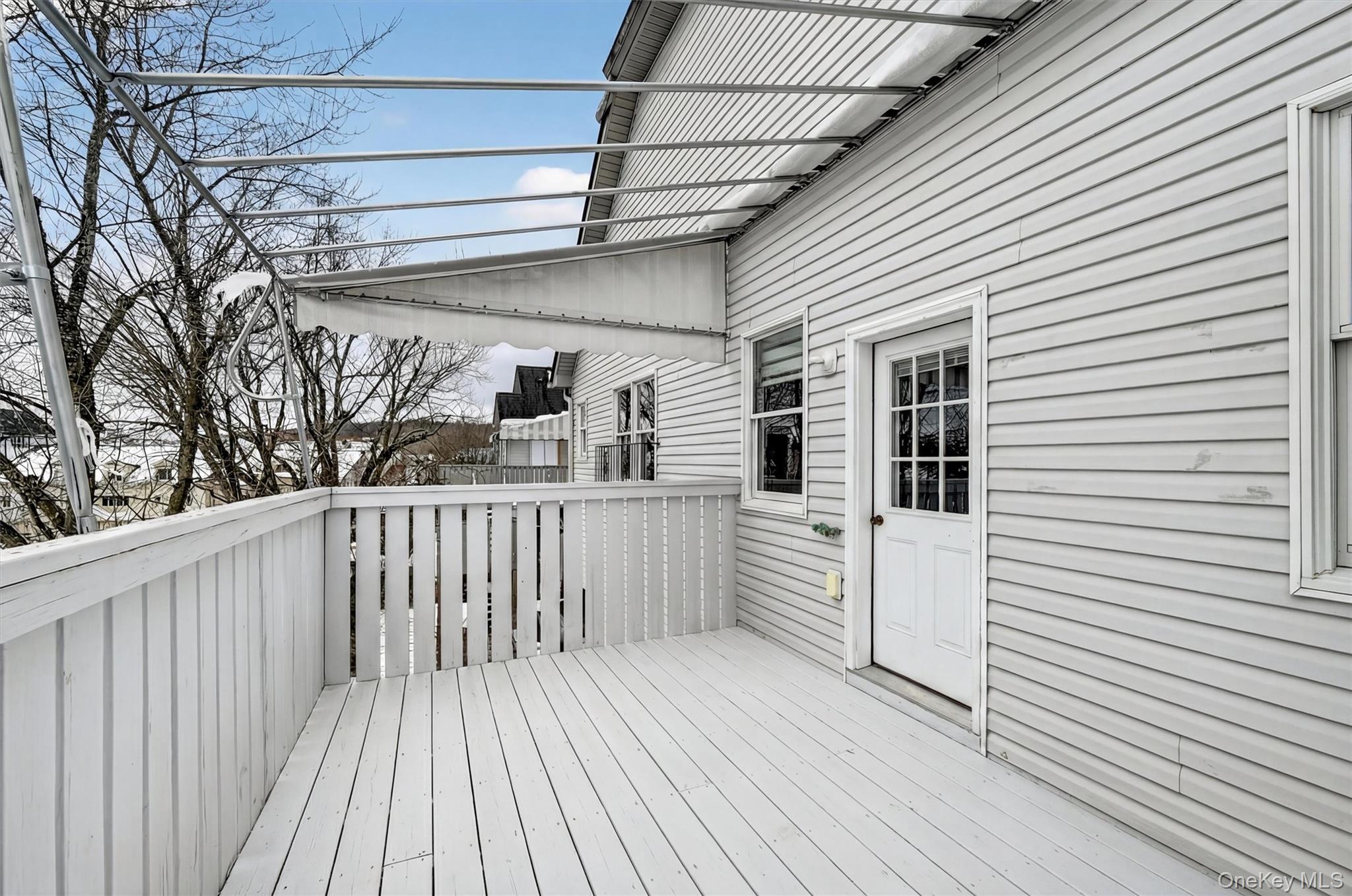6 Garfield Road, Unit 311 Monroe, NY 10950 - Photo 25 of 32 a view of a deck with wooden floor and fence with a wooden fence