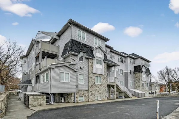 a view of city with cars and cars parked on the roadside
