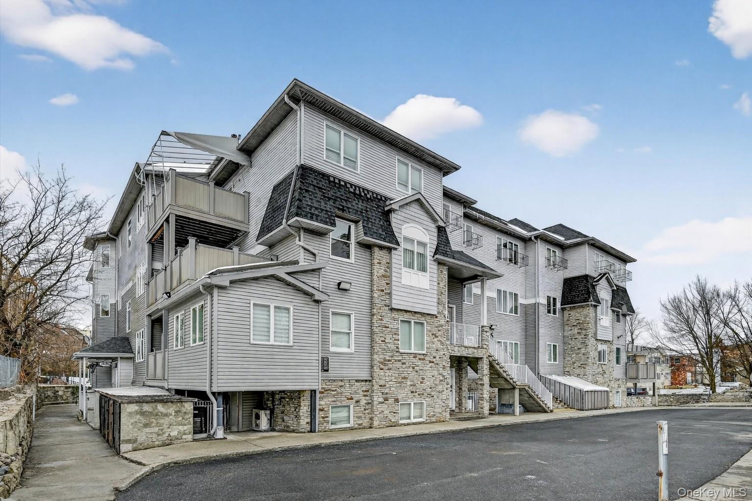 6 Garfield Road, Unit 311 Monroe, NY 10950 - Photo 26 of 32 a view of a big house with a street