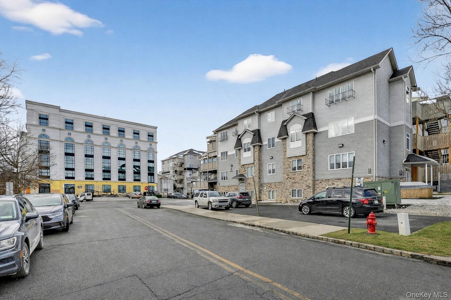 6 Garfield Road, Unit 311 Monroe, NY 10950 - Photo 27 of 32 a view of city with cars and cars parked on the roadside