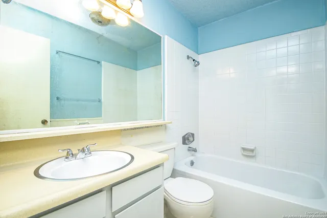 a bathroom with a sink a toilet and a bathtub