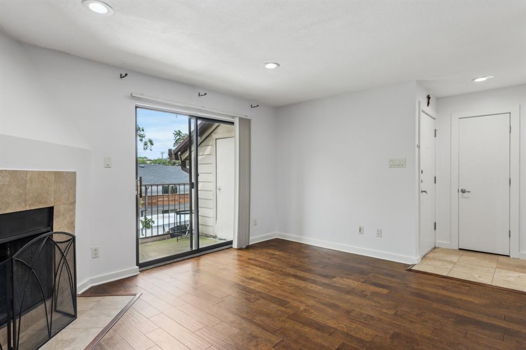 4777 Cedar Springs Road, Unit 6N Dallas, TX 75219 - Photo 12 of 24 a view of empty room with wooden floor and fireplace