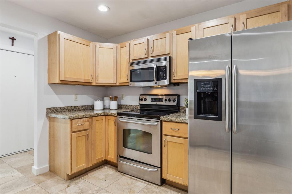 4777 Cedar Springs Road, Unit 6N Dallas, TX 75219 - Photo 15 of 24 a kitchen with cabinets stainless steel appliances and a counter space