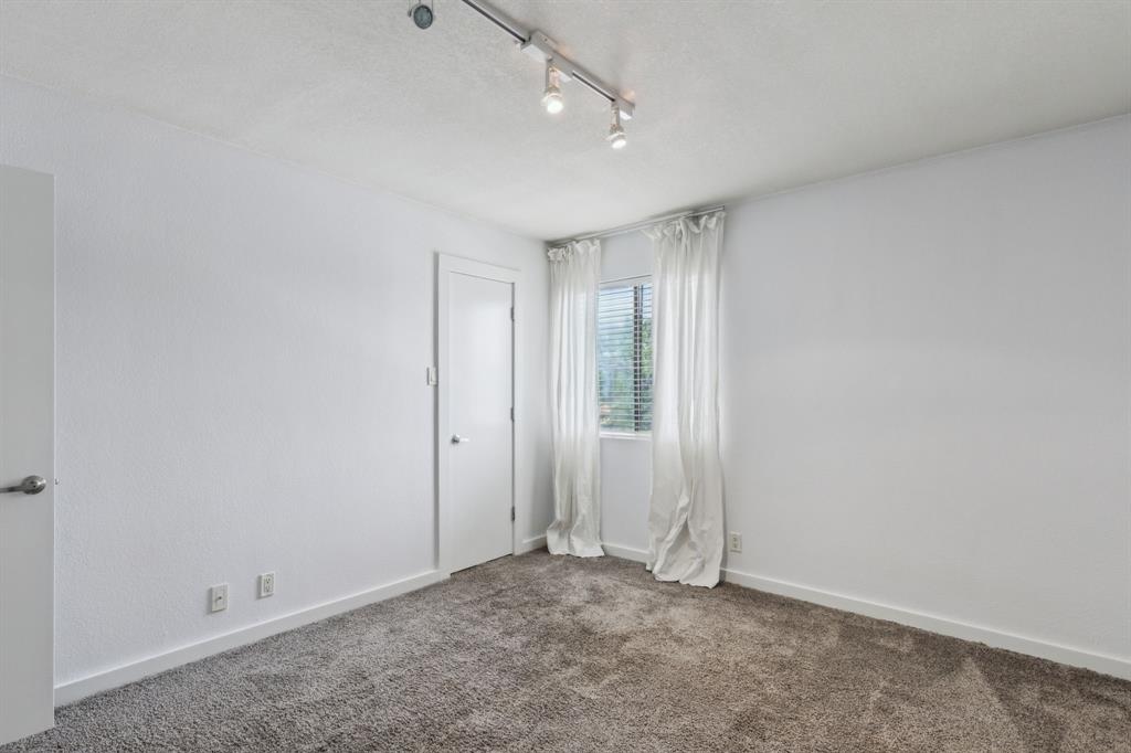 4777 Cedar Springs Road, Unit 6N Dallas, TX 75219 - Photo 17 of 24 an empty room with a empty space and windows